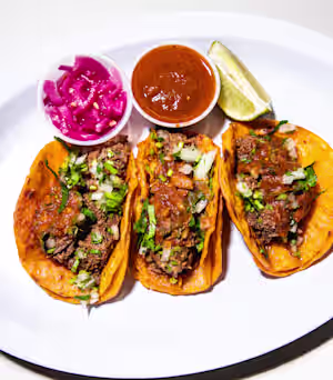 Birria Landia signature dishes TacosConsomméMulita Cheese QuesadillaTostadas